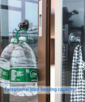 Heavy Duty Suction Cup Hook With Bombproof Grip For Window And Glass Walls featuring water bottles securely hanging on glass.