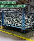 Blue industrial rolling cart with metal mesh sides on four swivel casters, loaded with metal scrap.
