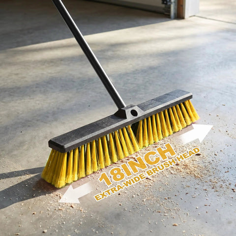 Heavy Duty 18 Inch Push Broom With Adjustable Metal Handle And Stiff Flagged Bristles on concrete floor, sweeping dirt.