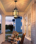 Built Like A Tank Modern Pendant Ceiling Light For Indoors Or Outdoors, Totally Waterproof Black Aluminum Porch Lantern Featuring Textured Water Ripple Glass, Includes Matching Bulb hanging over a porch, lighting a cozy seating area.