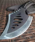 Close-up of Beast Fixed Blade Axe Knife With Saw Back And Sheath, black out color, on woven surface