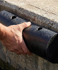 Rubber Dock Guard For Operations Semi Circular Dock Protector being installed on a concrete edge