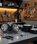 Four Piece 48MM Rubber Toy Car Wheel Set For RC Models, Dope Black Simulation Wheels placed on a workshop table with tools