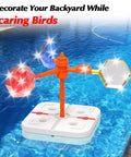 Floating Reflective Windmill Bird Deterrent For Pools And Yards Keeps Ducks Geese Pigeons Crow And More Away With Flashing Red And Silver Disturbance And Moving Visuals For Boats Roofs Gardens Backyards installed in a pool.
