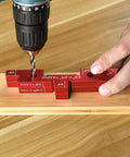 Close-up of Aluminum Setup Blocks 14 Piece Set With Case For Woodworking in use with a drill on wooden surface.