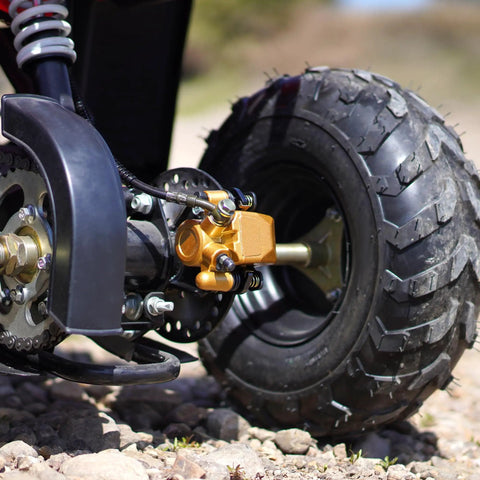 Close-up of rear brake caliper go kart brake kit with beefy performance brake pads on a 50cc to 250cc ATV wheel, easy install.