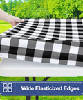 Waterproof Elastic Fitted 6Ft Picnic Table Cloth 2 Pack Buffalo Plaid Black White 30x72 Inches being put on a table