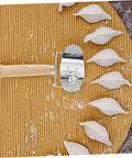 Knock Out Perfect Dumpling Wrappers Effortlessly With This Three Piece Stainless Steel Roller Set on bamboo mat with dumpling shapes.