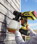 Person using Cordless Paint Sprayer Gun With 4.0Ah Battery And Fast Charger 550W HVLP Sprayer for painting exterior wooden wall