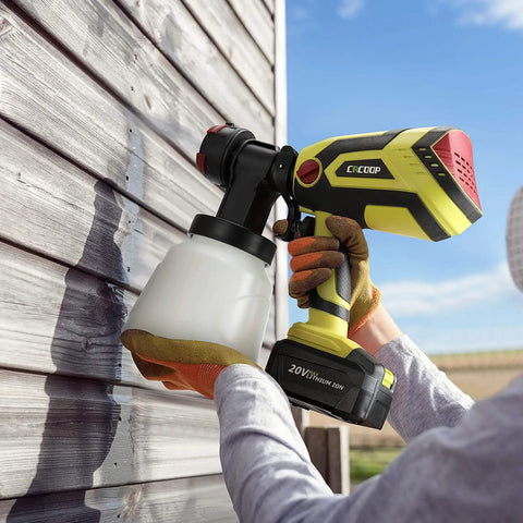 Person using Cordless Paint Sprayer Gun With 4.0Ah Battery And Fast Charger 550W HVLP Sprayer for painting exterior wooden wall