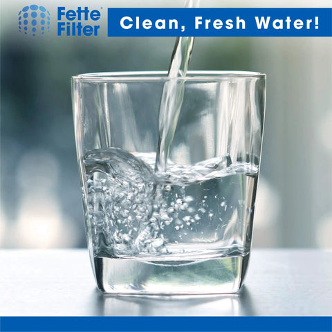 Pouring water into a clear glass representing 24 Pack Countertop Distiller Water Filters For Megahome And Other Countertop Distillers