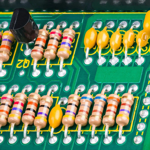 Close-up of 25 Value One Quarter Watt Carbon Film Resistor Kit From One Ohm To One Mega Ohm Five Percent Axial Lead Assortment soldered on a board