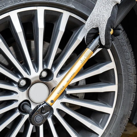 Twenty Two Piece Torque Wrench Set Half Inch Drive Ten To One Hundred Eighty Foot Pounds And Thirteen Point Six To Two Hundred Forty Four Point One Nm Includes Impact Sockets Seventy Two Tooth Quick Release Ratchet And Click Torque For DIY Car Repair, shown tightening car wheel lug nuts