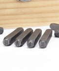 Close-up of metal punches from 36 Piece Letter And Number Stamp Set With 6mm Height In A Wooden Case Beefy 40Cr Alloy Steel