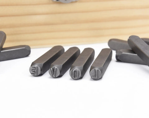 Close-up of metal punches from 36 Piece Letter And Number Stamp Set With 6mm Height In A Wooden Case Beefy 40Cr Alloy Steel