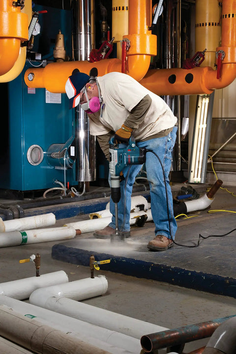 Worker using 3 9/16 Inch Rotary Hammer Core Bit Set with Wave Design for drilling in industrial setting