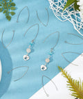 V Shape Earring Hooks With Horizontal Loop In 304 Stainless Steel For DIY Jewelry Making on blue surface with greenery