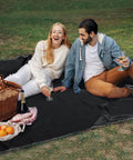 Couple enjoying a picnic on Ultralight Tent Footprint Tarp 55x87 Inches Waterproof PU2000mm Ground Cloth for Camping and Hiking