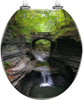 Round Resin Toilet Seat for Hiking Trail Restrooms with a scenic landscape design featuring a waterfall and greenery.