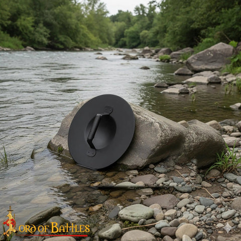 Old School Medieval Steel Buckler Shield Handcrafted With Wooden Grip, 16 Gauge, 30 Cm Round, on river rock
