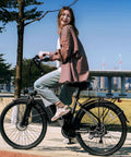 Person riding High Power 1000W Peak Electric Bike For Adults With 22 MPH Top Speed And 60 Mile Range 26 Inch Commuter E Bike