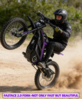 Badass 8000W Electric Dirt Bike For Adults With 75 Mile Range And 60 Mph Top Speed performing a wheelie on dirt trail.