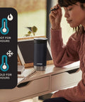 Woman at a desk with 16 Oz Licorice Vacuum Insulated Stainless Travel Mug With Leak Proof Lid Keeps Drinks Hot Up To 6 Hours Or Cold Up To 12 One Hand Sip