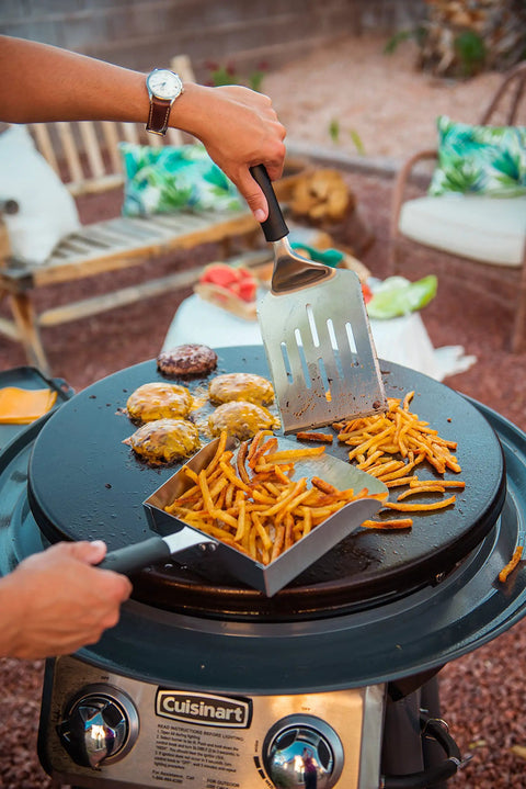 Extra Large Stainless Steel Griddle Food Mover Spatula with 5 Cup Capacity transferring fries on outdoor grill.