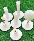 16 Piece Golf Tee Set With Rubber Stands And Bamboo Tees For Mats displayed on artificial turf with golf ball