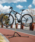 Heavy Duty Bike Repair Stand With 360 Degree Rotating Clamp Holds 1 In To 1.75 In Tubes Rubber Protected 80 Lb Capacity outdoors