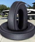 Heavy Duty Trailer Tire Set With 6PR Load Range C 12 Inch All Weather Tires in front of utility boat and trailer