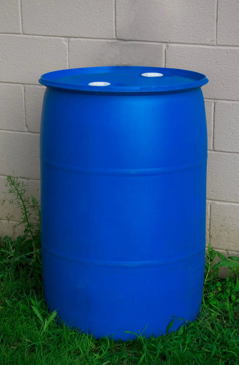 Heavy Duty 55 Gallon Plastic Drum Stackable Industrial Storage Barrel Chemical Resistant Liquid Container Made From Tight Head High Density Polyethylene In Blue placed on grass.