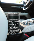 A black insulated stainless steel tumbler for sailplane pilots and glider enthusiasts sits in a car cup holder.