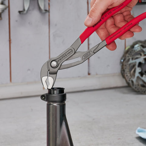 Cobra Water Pump Pliers, 10 Inch, with Adjustable Jaw and Self Locking Grip for Pipes and Nuts in use on a metal pipe
