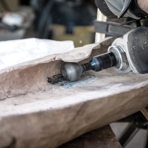 Close-up of Ball Gouge Attachment for Angle Grinder Pro Grade Power Carving Tool for Hollowing Small Concave Surfaces 30 Millimeter Diameter Self Sharpening Rotatable Replaceable Blade Arbortech BAL FG 2000 in use on wood.