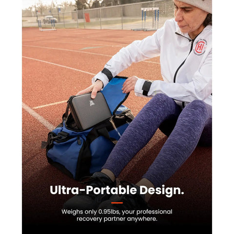 Person placing Q2 Ultra Mini Massage Gun With Red Light Infrared Heat Head into a gym bag at a track, illustrating its portability.
