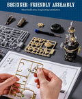 Hands assembling Navi Lighthouse Mechanical 3D Puzzle lighted DIY building set for adults with parts and instructions visible.