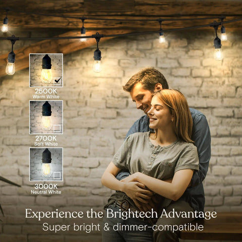 Ambience Pro Waterproof LED Outdoor String Lights for Patio 48 Ft With 15 Hanging Dimmable 2W Vintage Edison Bulbs lit over couple