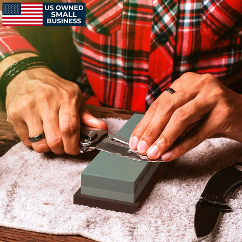Person sharpening knife on Two Sided Whetstone Knife Sharpening Stone 400/1000 Grit Kit With Flattening Stone And Non Slip Base