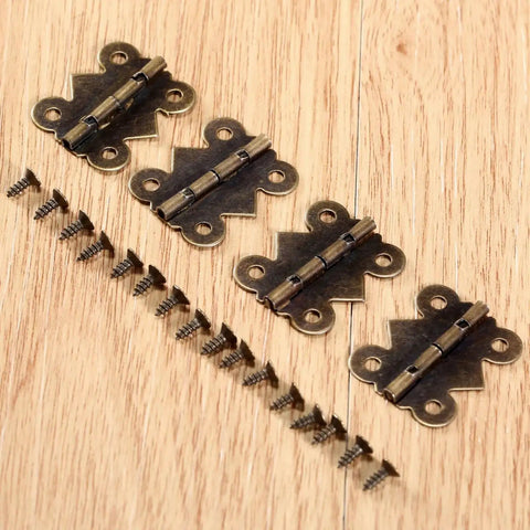 Antique Bronze Decorative Butterfly Hinges Set For Cabinets Drawers And Jewelry Boxes, 25mm By 20mm, with screws, on wood surface.