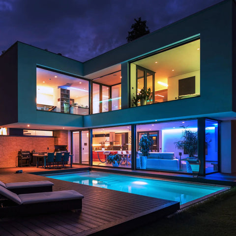 Modern house exterior with color-changing LED lights, showcasing Smart Recessed 5 To 6 Inch LED Downlights With WiFi.