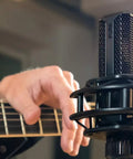 Musician using LCT440PURE 1 Inch True Condenser Microphone with Cardioid Pattern for Studio Stage and Home Recording.
