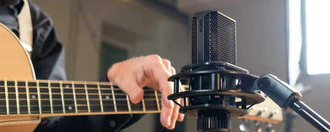 Musician using LCT440PURE 1 Inch True Condenser Microphone with Cardioid Pattern for Studio Stage and Home Recording.