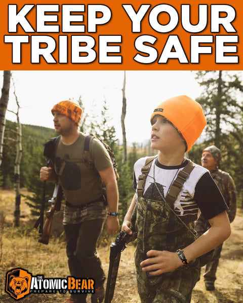 Group of people hiking in camouflage outfits, wearing orange hats, carrying gear, with text 'Keep Your Tribe Safe' above.