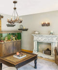 Farmhouse living room with rustic decor, featuring a wooden coffee table, antler chandelier, and fish tank in cozy setup.