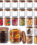 24 Pack Glass Canister Set With Tight Wood Lids For A No Sweat Pantry Setup, 17 Oz Food Jars filled with various snacks and ingredients.