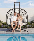 Double Hanging Egg Chair With Stand For Indoor And Outdoor Use Cozy Comfy Two Person Swing Chair Removable Cushions Heavy Duty 700 Lbs Capacity Patio Garden Bedroom Black Beige by the pool.