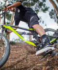 Mountain biker wearing the Dope Quick Lace Ankle Brace 2.0 for all sports enthusiasts, fast slip on support for BMX MTB riding.