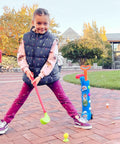 Toddler Golf Club Set With Pull Cart For Little Pros Ages One To Five Includes Super Lightweight Gear And Soft Ball For No Sweat Swinging And Pretty Sweet Motor Skill Progression Daily, child preparing to swing club.