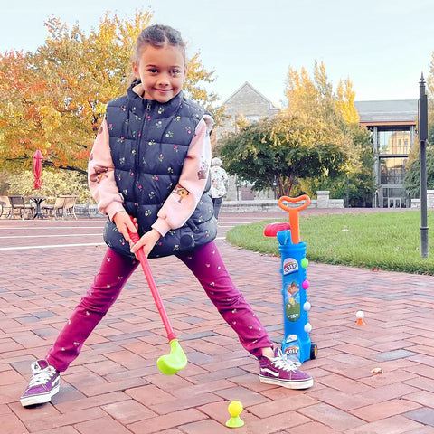 Toddler Golf Club Set With Pull Cart For Little Pros Ages One To Five Includes Super Lightweight Gear And Soft Ball For No Sweat Swinging And Pretty Sweet Motor Skill Progression Daily, child preparing to swing club.